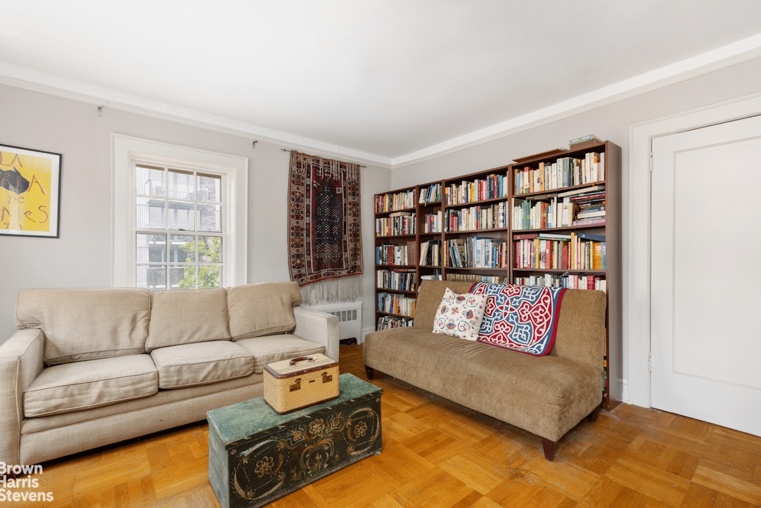 A study-like bedroom with parquet flooring and picture rail