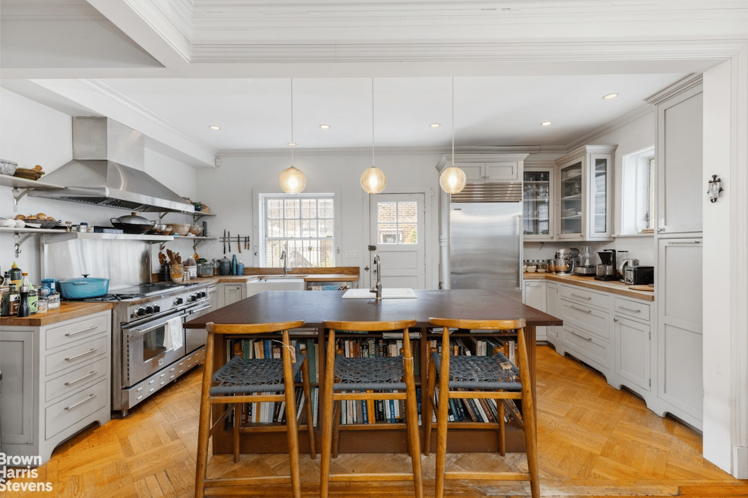 kitchen with pale cabinets, parquet floor, and large center island