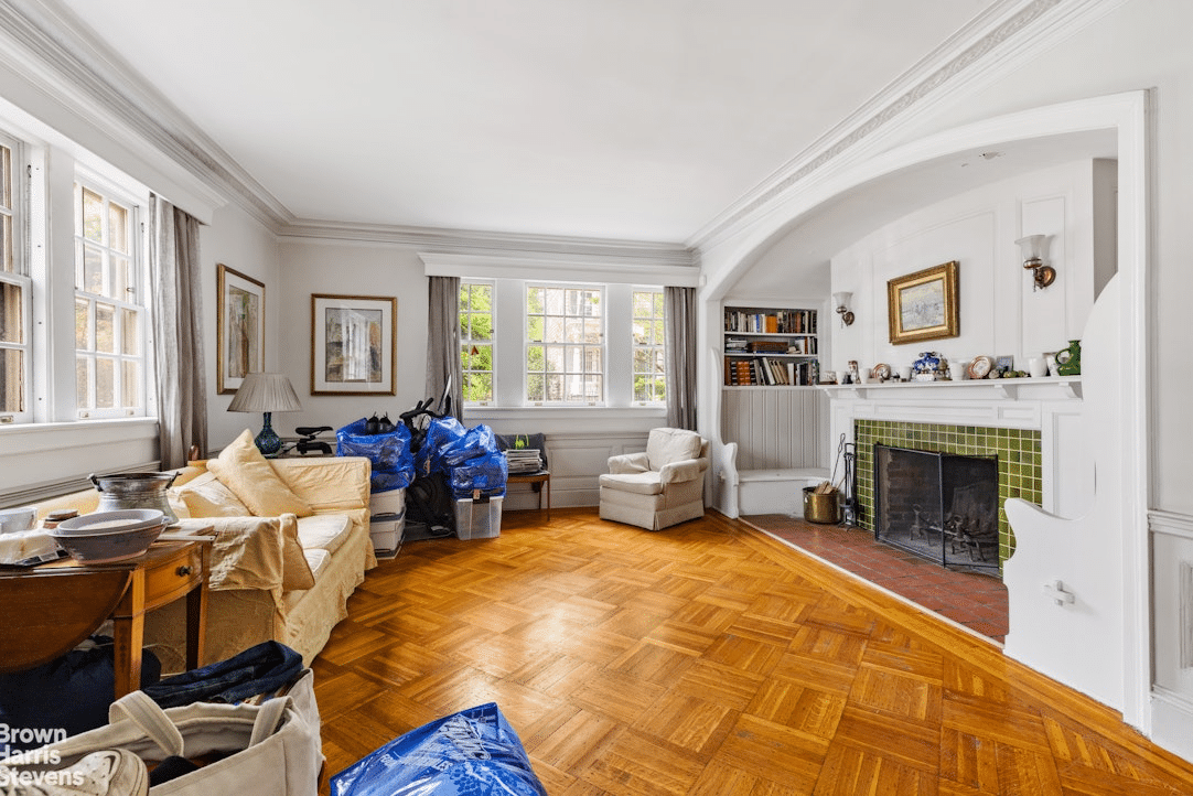 parlor with parquet floor, inglenook with fireplace with green tile