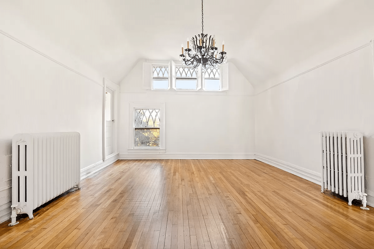 bedroom with wood floor, picture rail, white walls