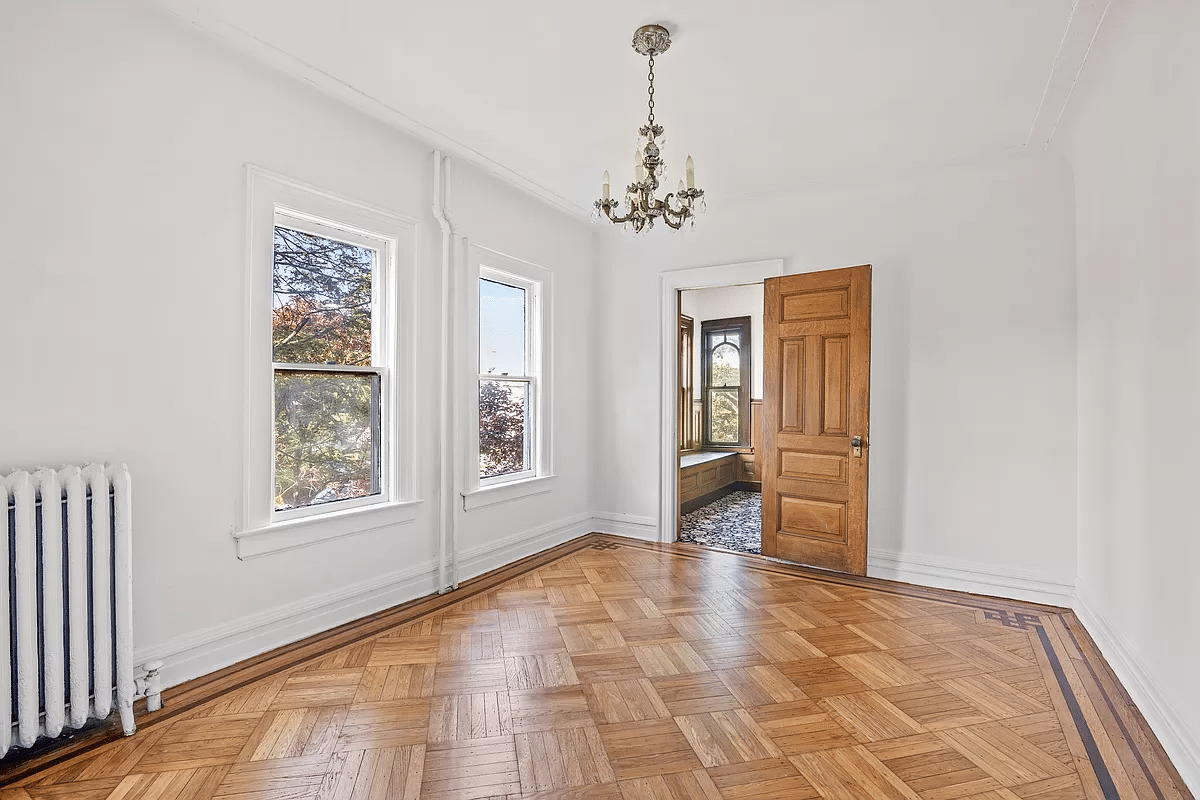 bedroom with wood floor, doo open to the stair landing