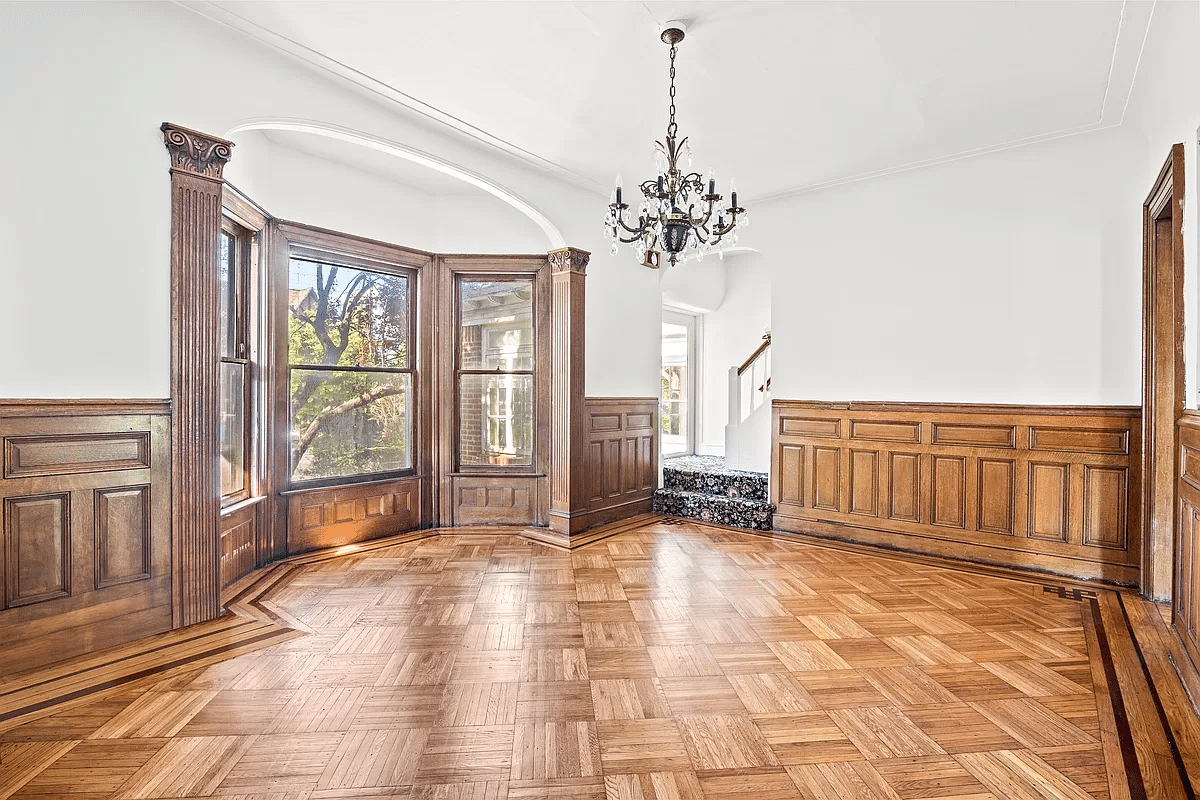 dining room with unpainted wainscoting and moldings