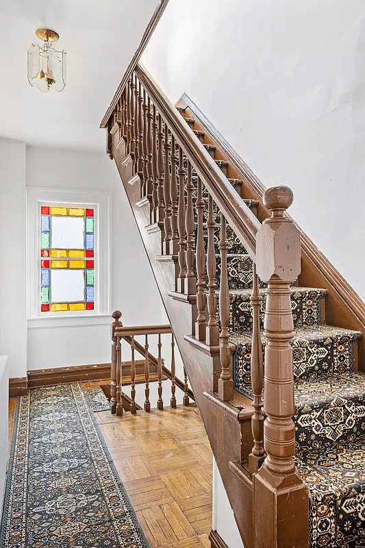 stair hall with a stained glass window