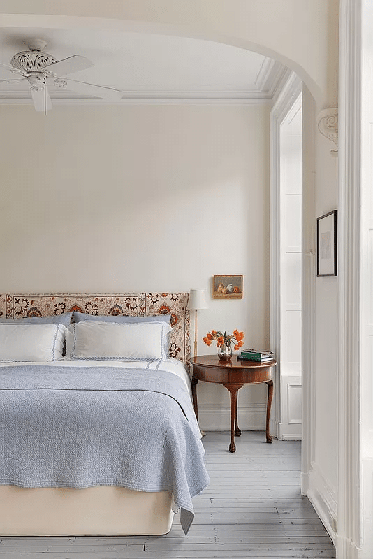 bedroom with gray painted wood floor and bed niche