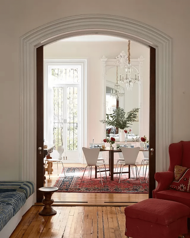 view from parlor through arched doorway with pocket doors to dining room