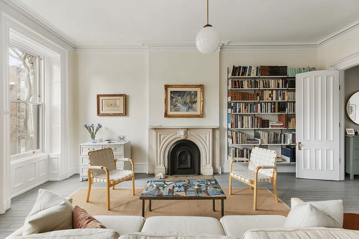 bedroom with seating area with marble mantel, wood floor painted gray