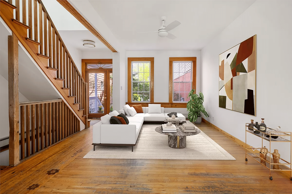 parlor with wood floors, staircase