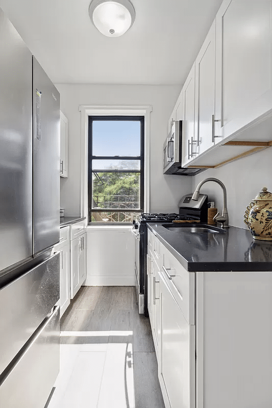 windowed kitchen with white cabinets