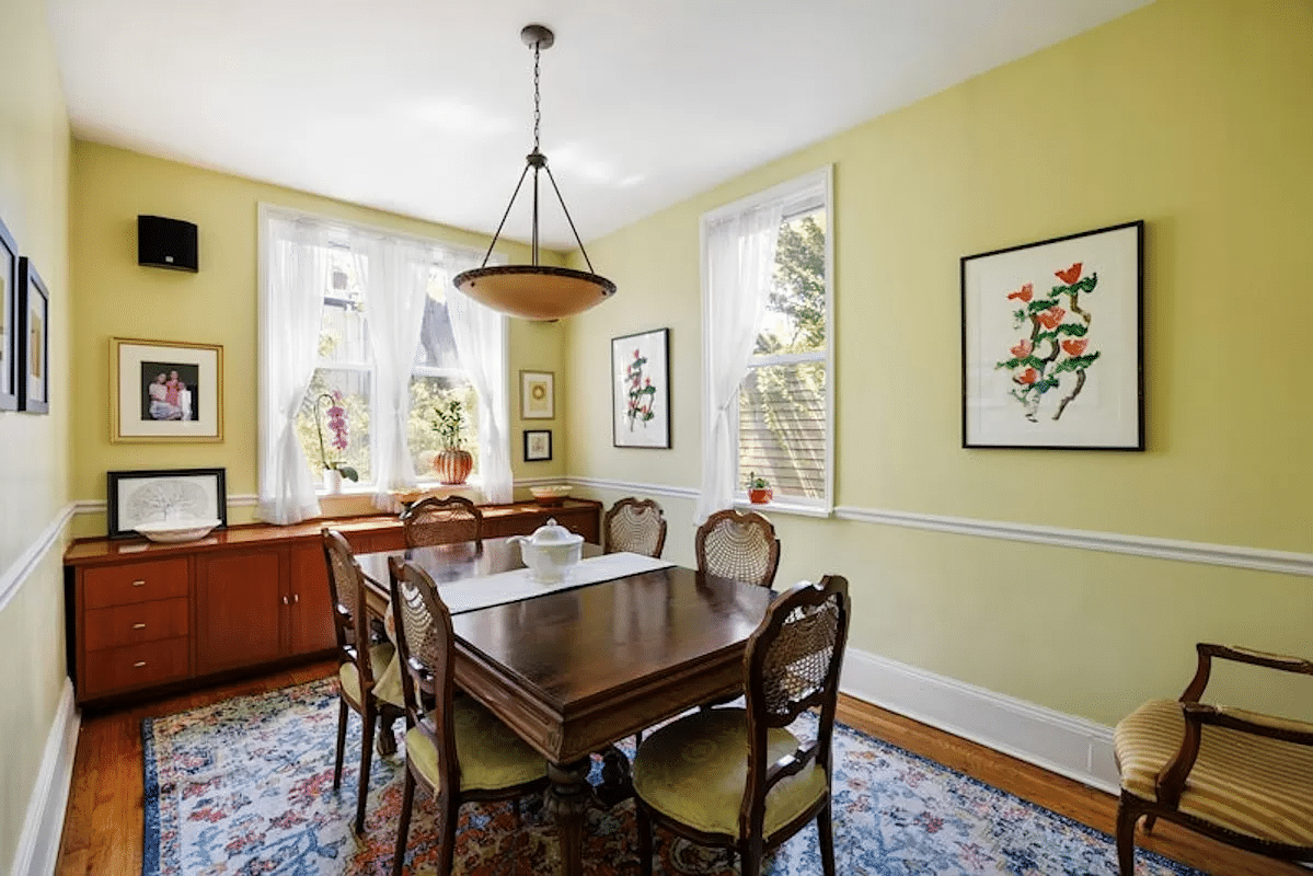 dining room with yellow walls and a chair rail