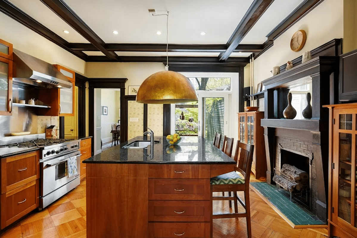 kitchen in former dining room with beamed ceiling, mantel