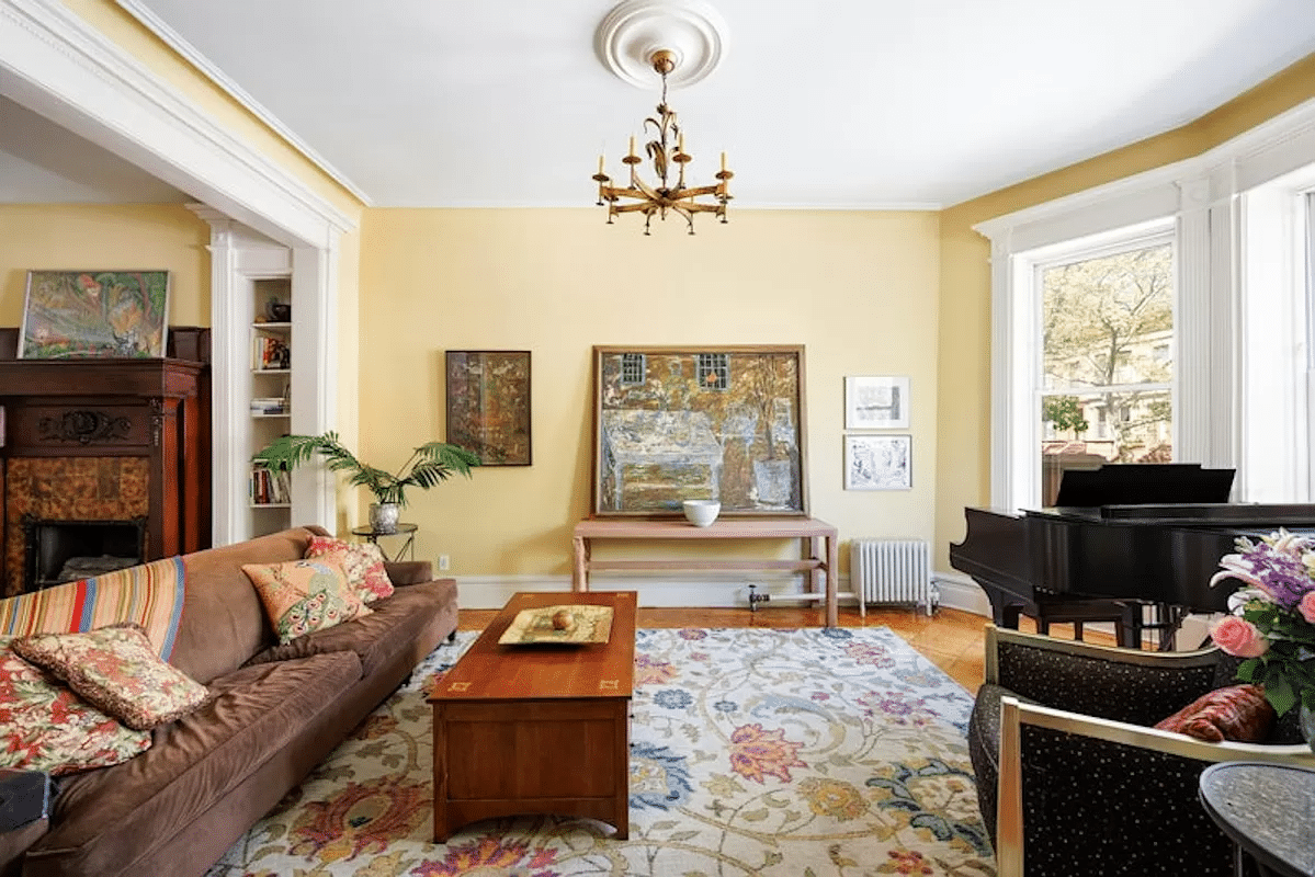 prospect lefferts gardens - parlor with yellow walls, wood floor, view into middle parlor