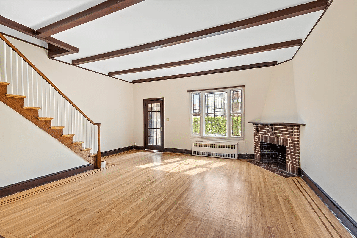 living room with a brick corner fireplace and woof floor