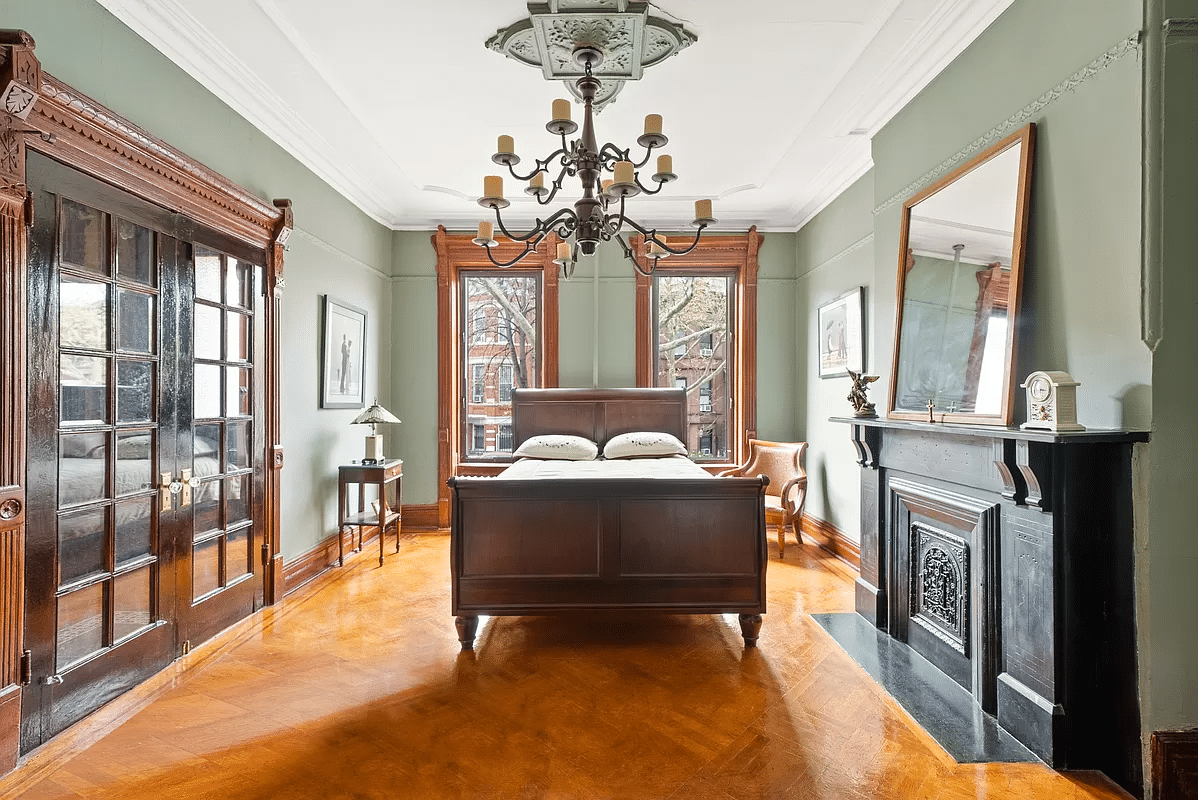 bedroom with mantel, wood floor