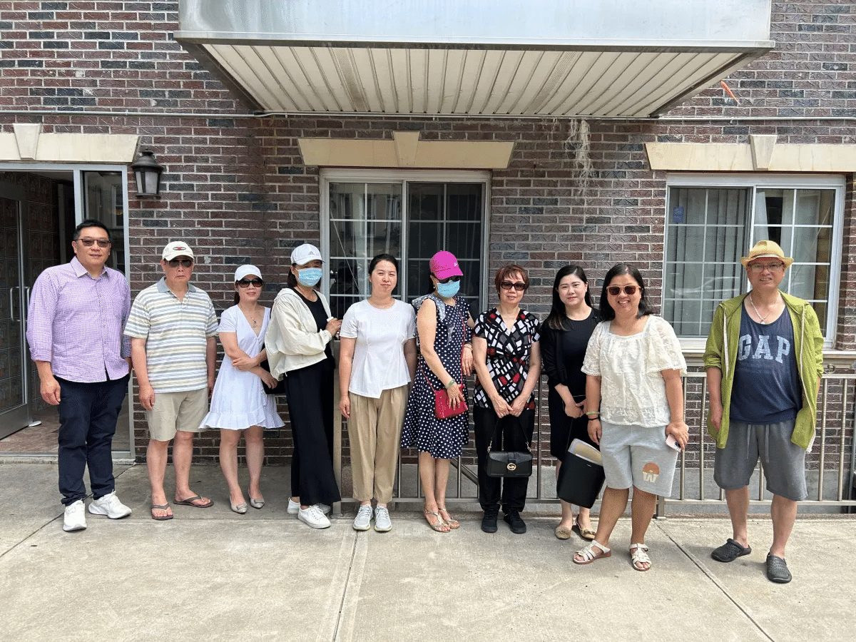 bay ridge - residents posing outside their brick building