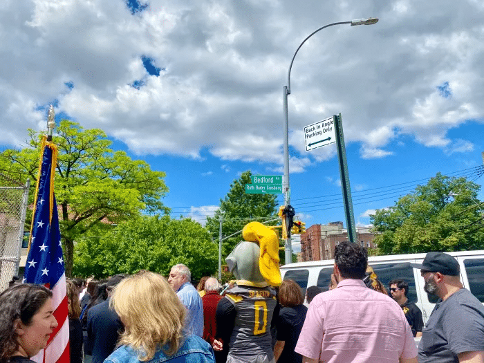 rgb- people gather around the street sign