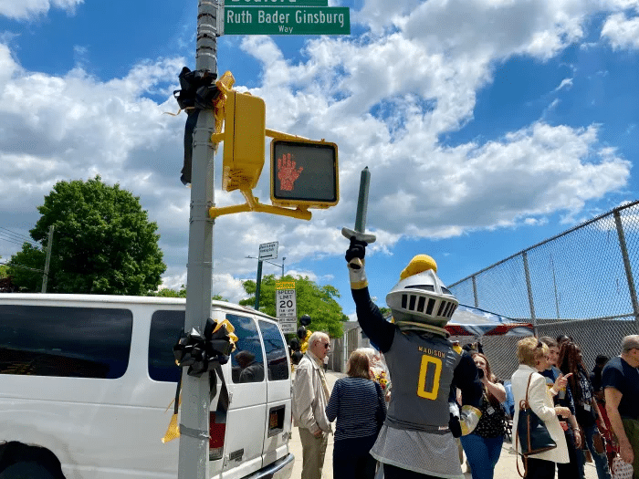 people around the street sign