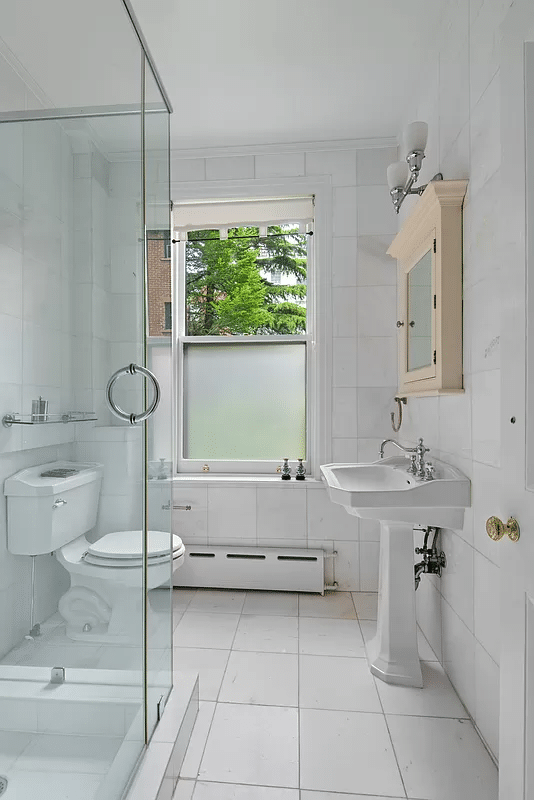 bathroom with shower, white tiles