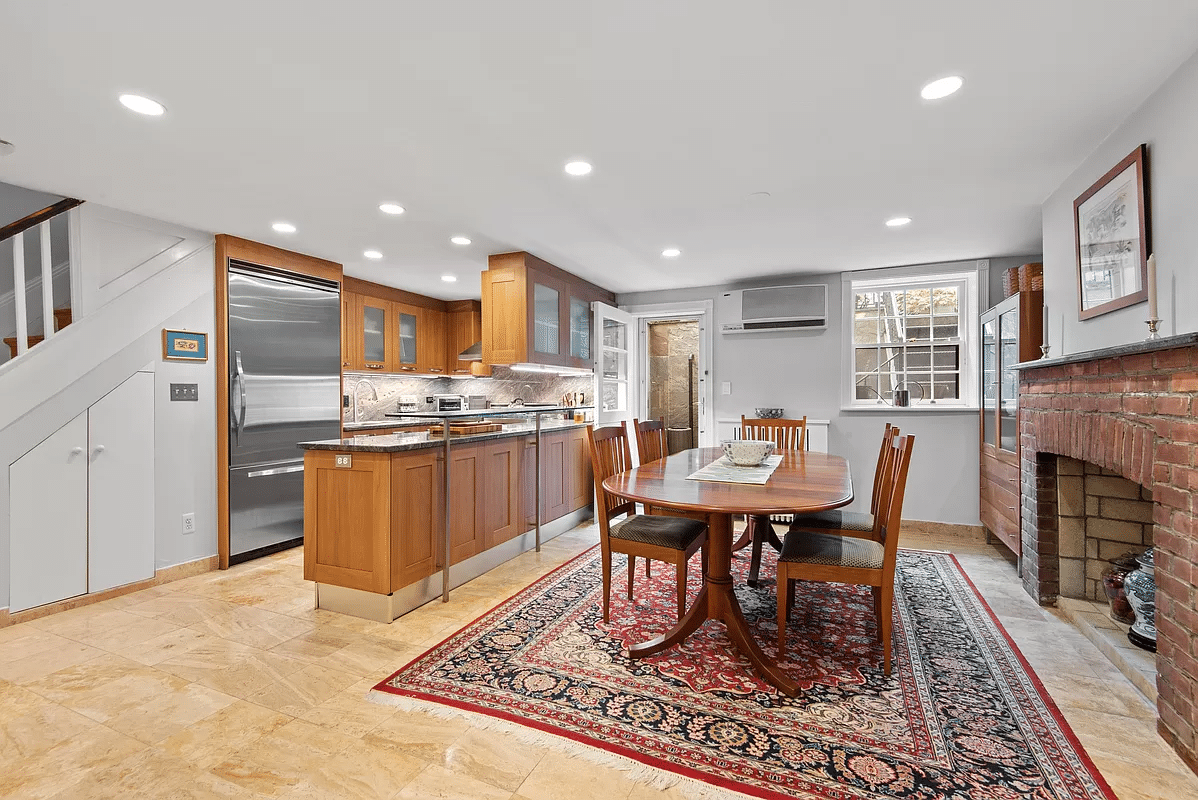 kitchen and dining room with tile floor, brick fireplace