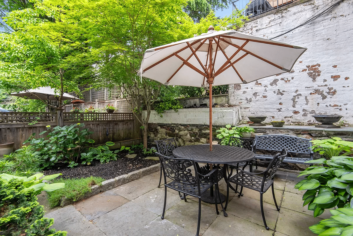 rear yard with stone patio and planting beds