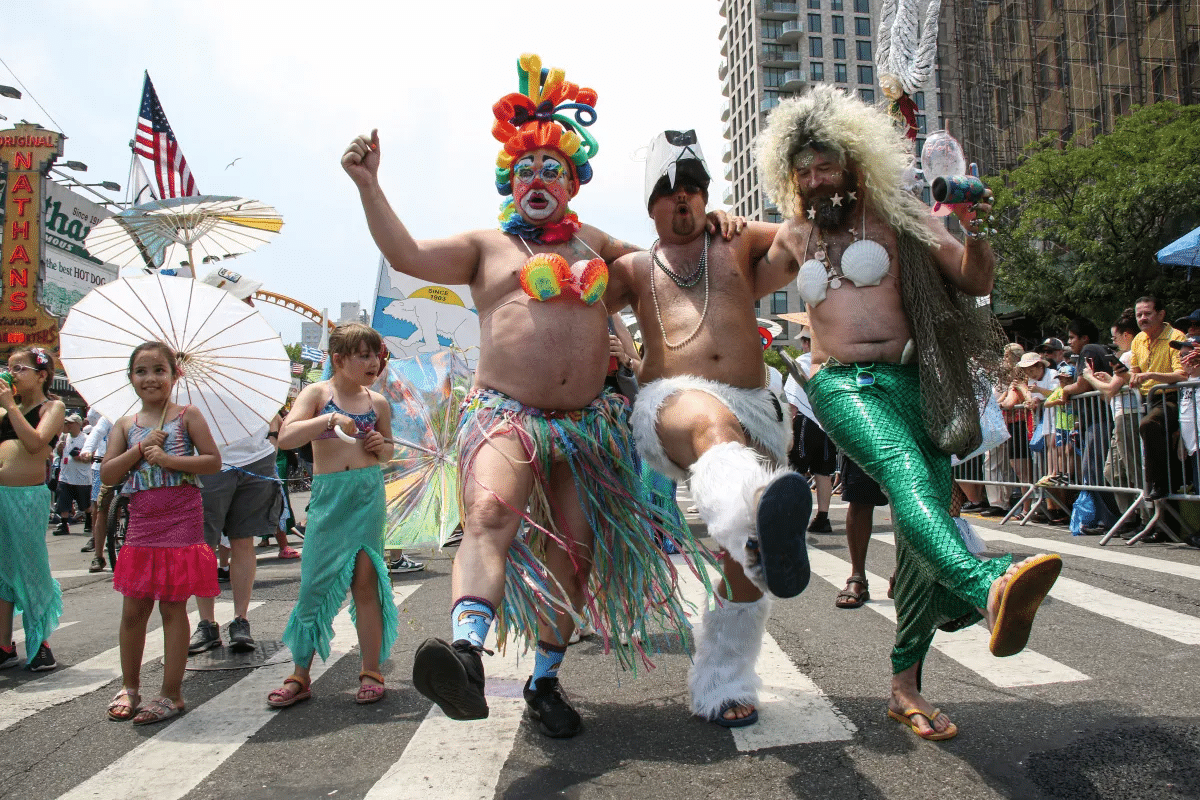 mermaid parade - costumed revelers marching in the parade