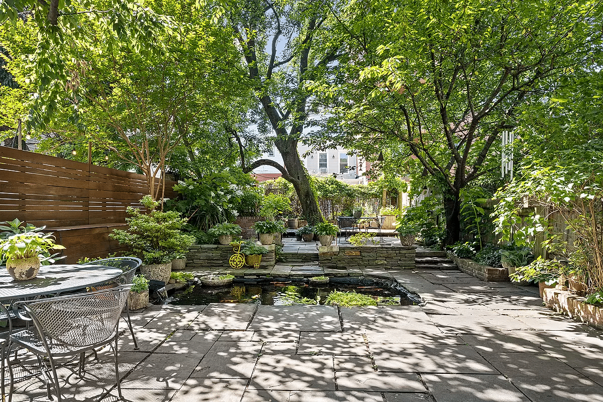 the rear yard with a pond and a raised rear level