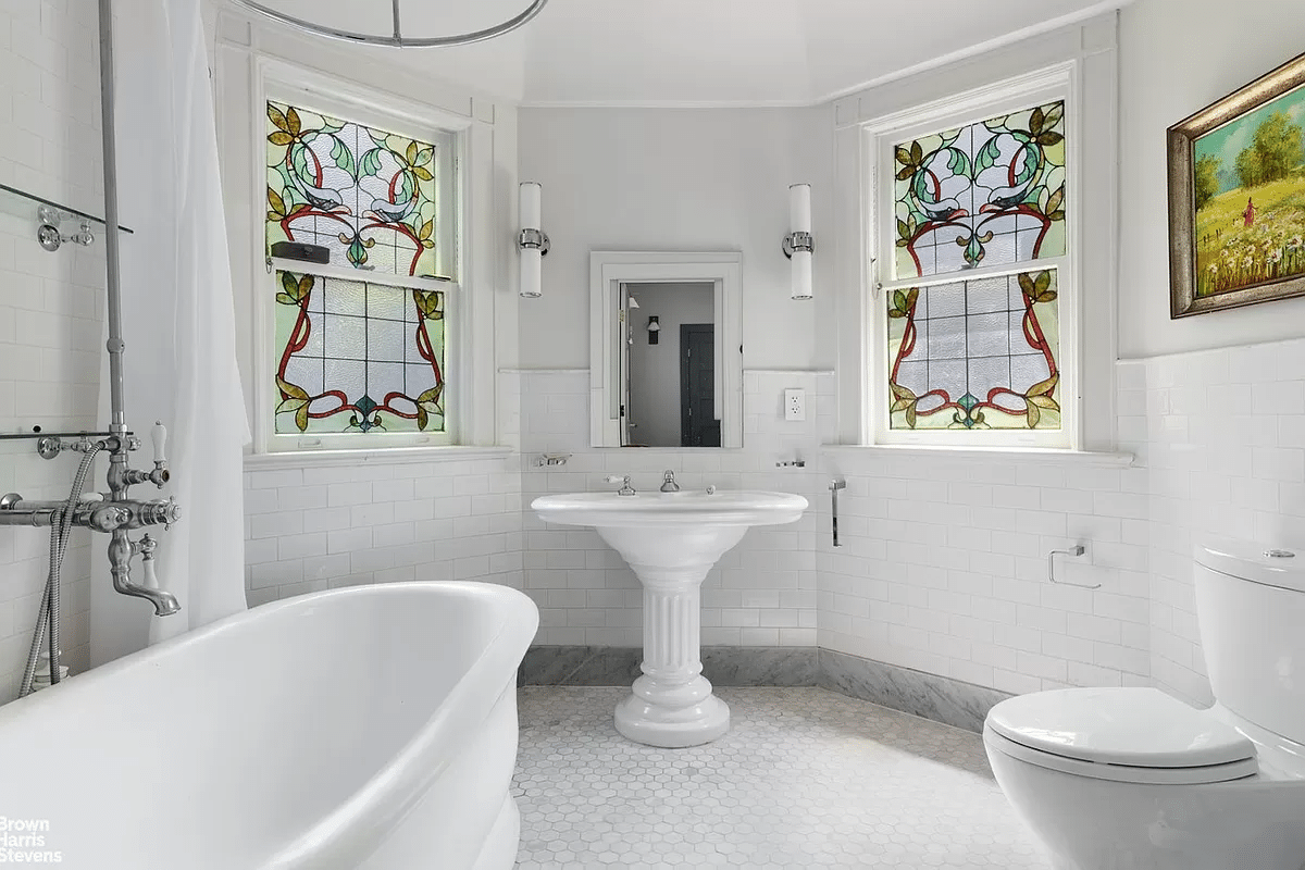 bathroom with stained glass, period inspired white fixtures