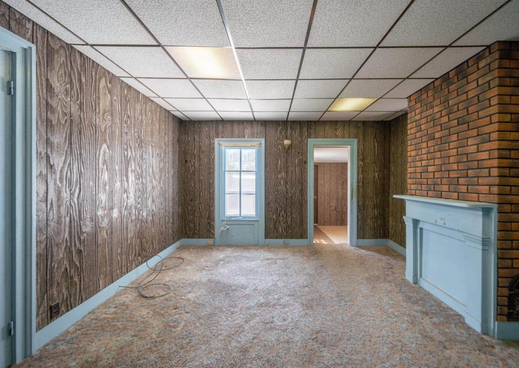 den with faux paneling, mantel, carpet