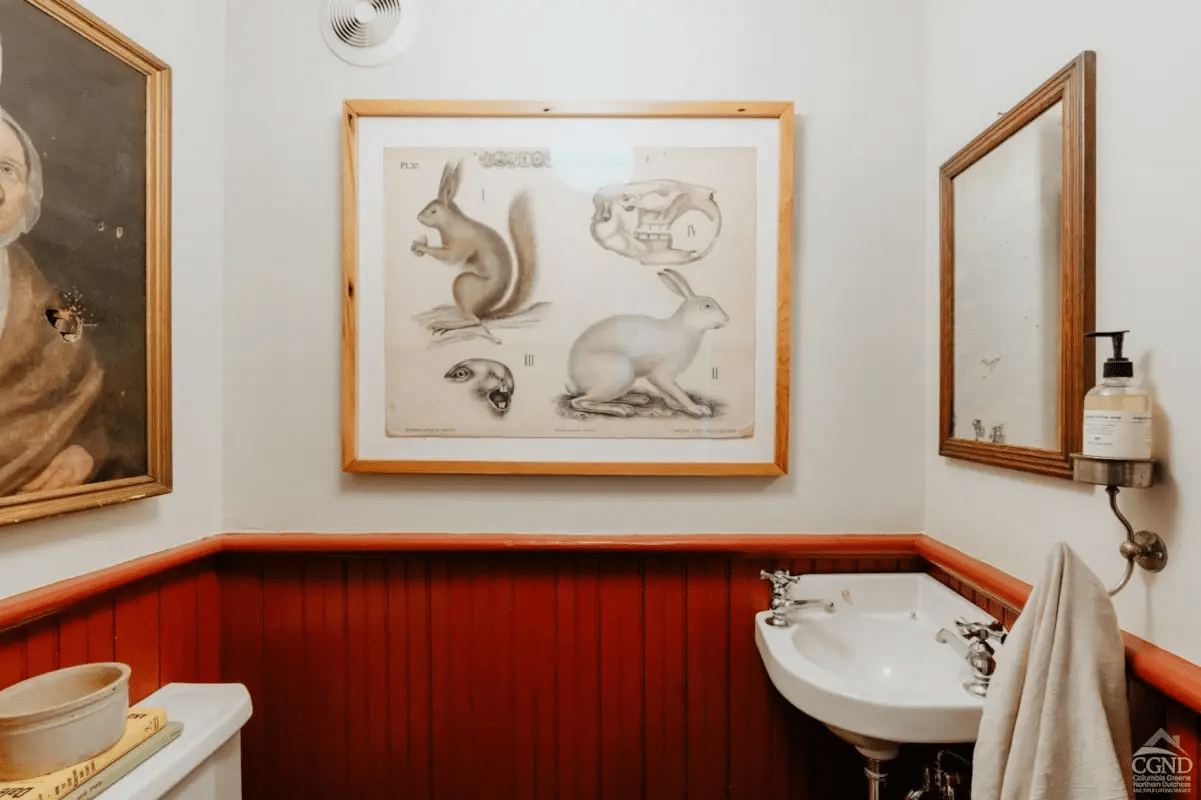 powder room with wainscoting, small corner sink