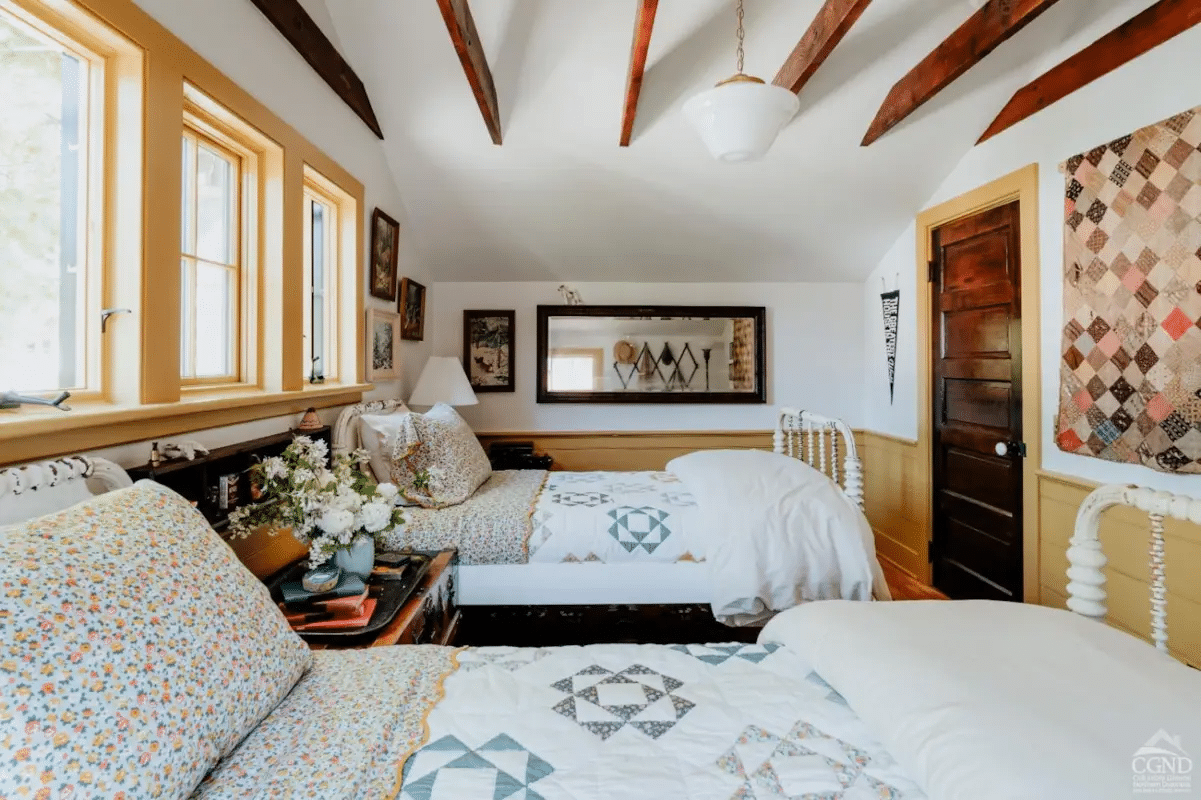 bedroom with wainscoting, trim painted mustard