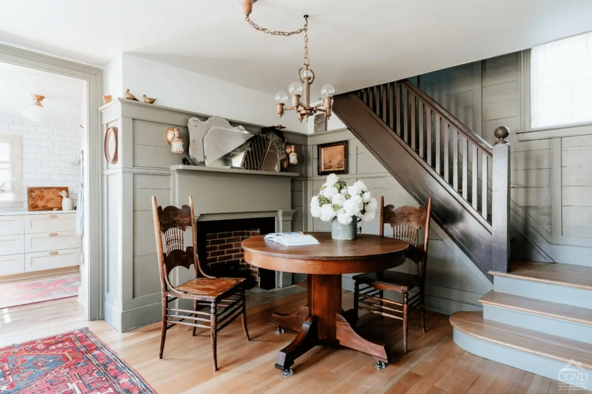 dining room with mantel and wainscoting painted green