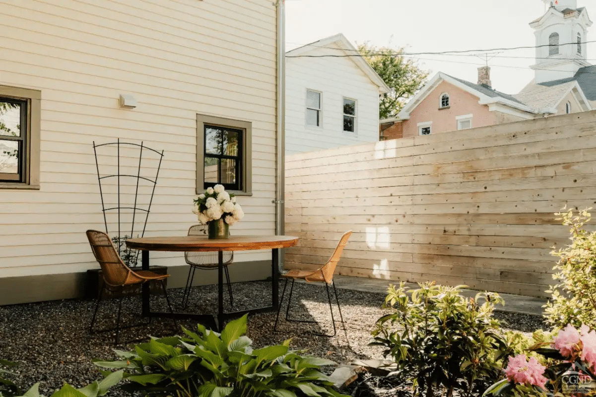 rear garden with a gravel patio and a horizontal fence