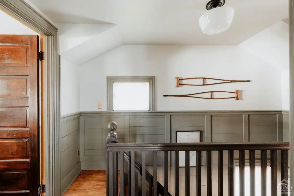 upstairs hallway with trim and wainscoting painted green