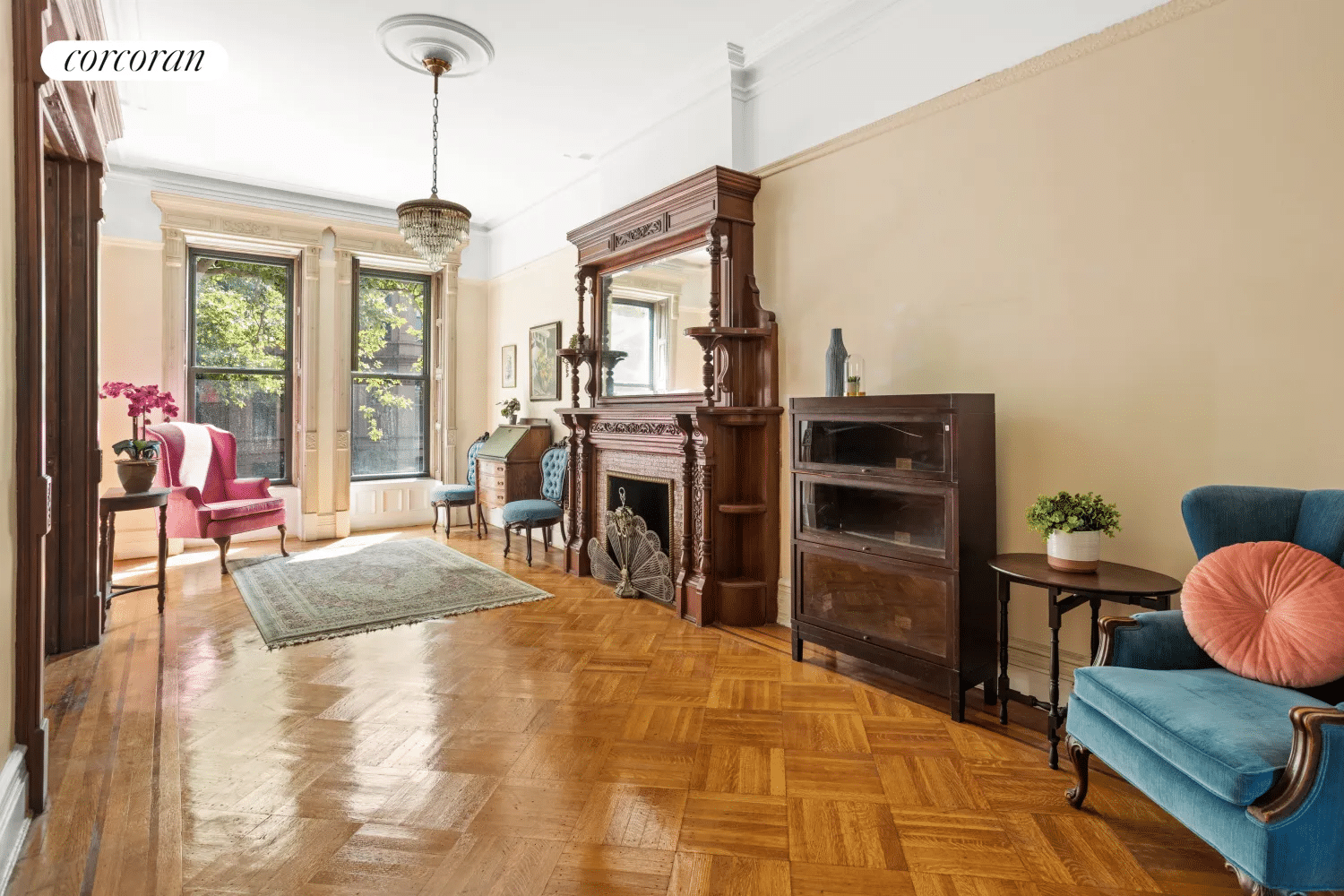 front parlor with wood floor, mantel, picture rails