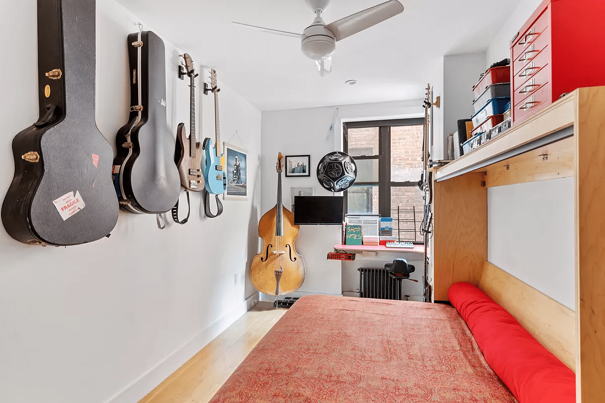 narrow bedroom with a ceiling fan