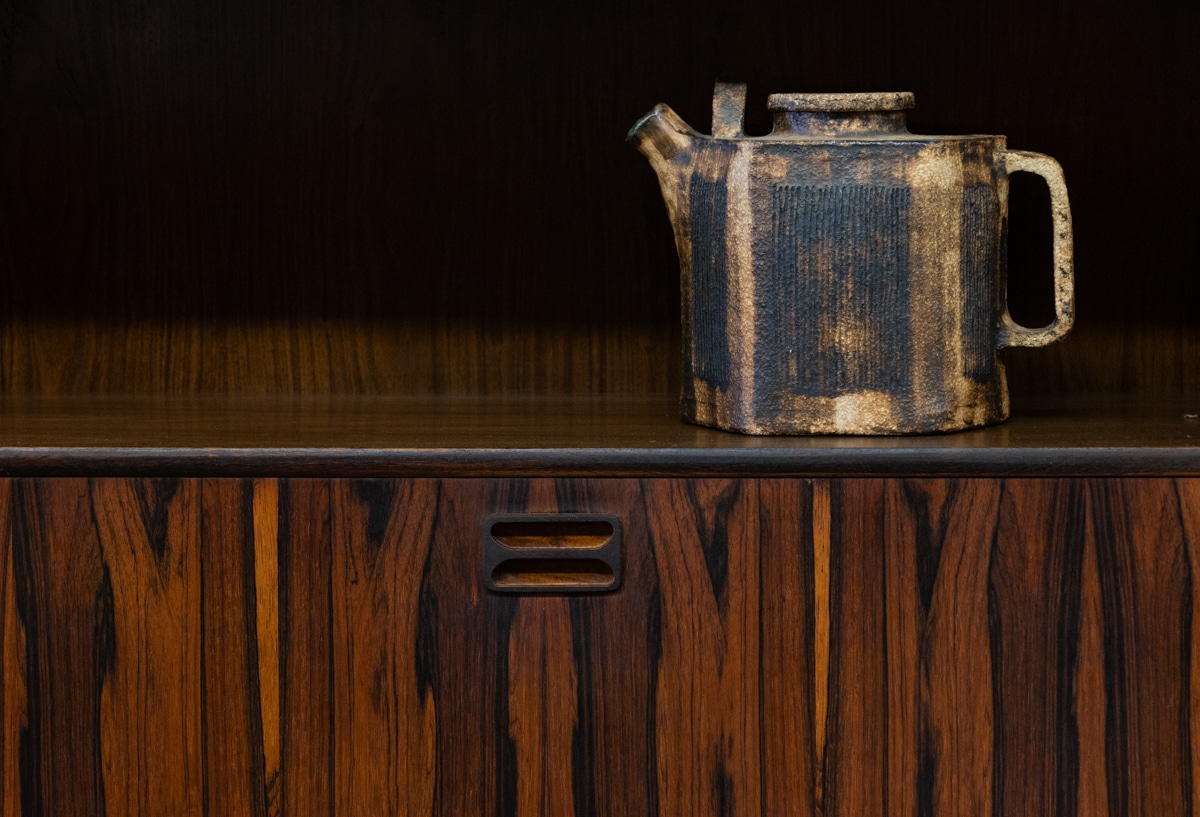 a teapot on a rosewood shef