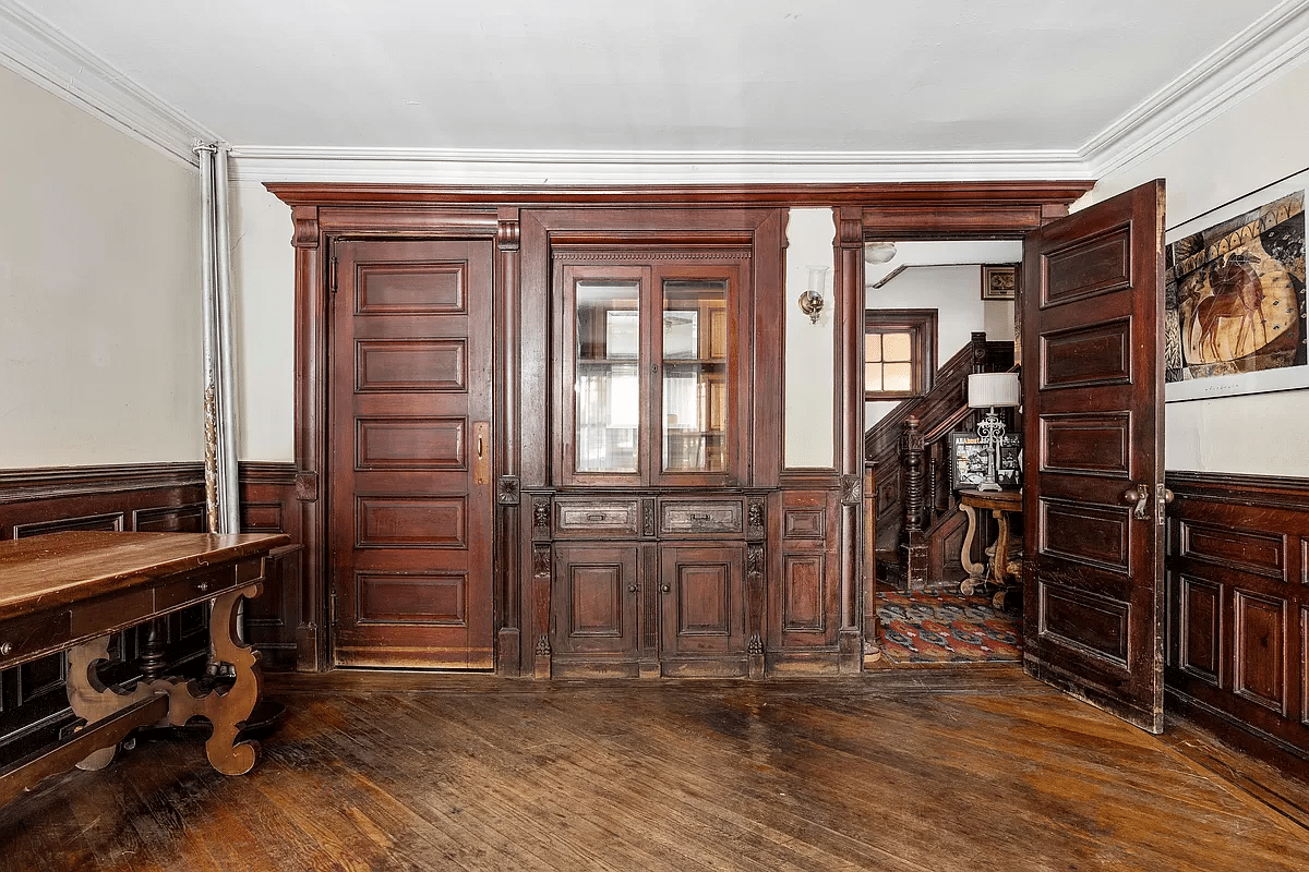 dining room with built-in china cabinet, wainscoting