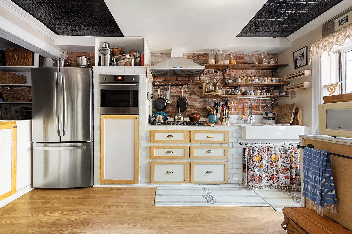 kitchen with exposed brick, partial tin ceiling