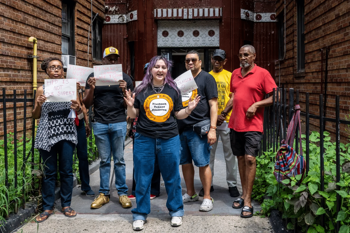 brooklyn tenants pose in front of their building