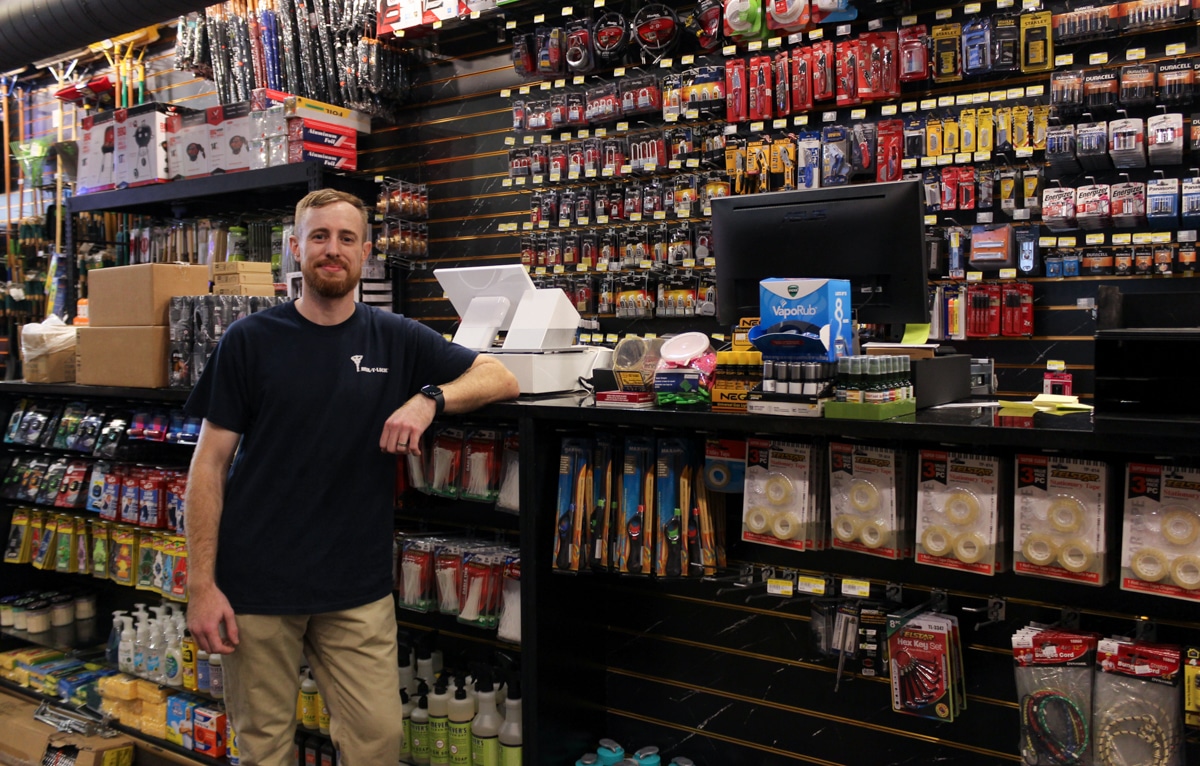 owner posing near the register