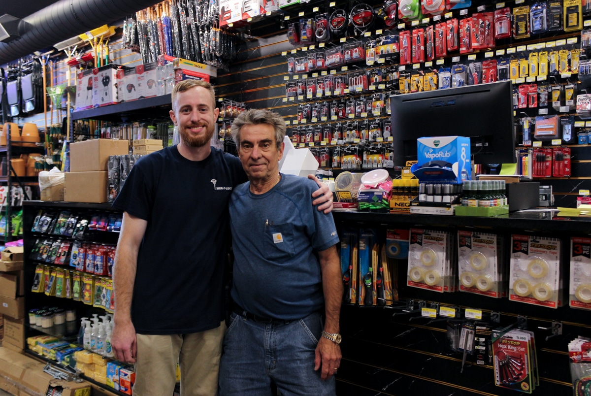 father and son posing near the register