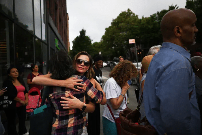 people embrace at rally