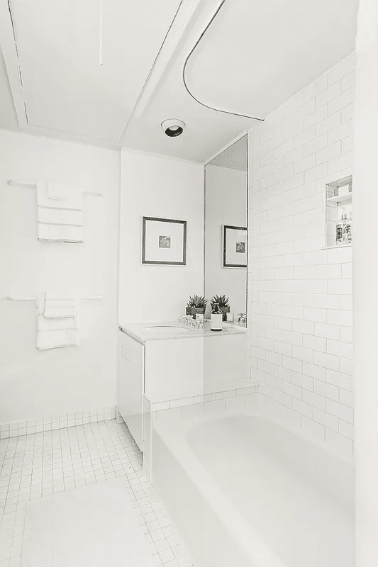 bathroom with white fixtures and tile