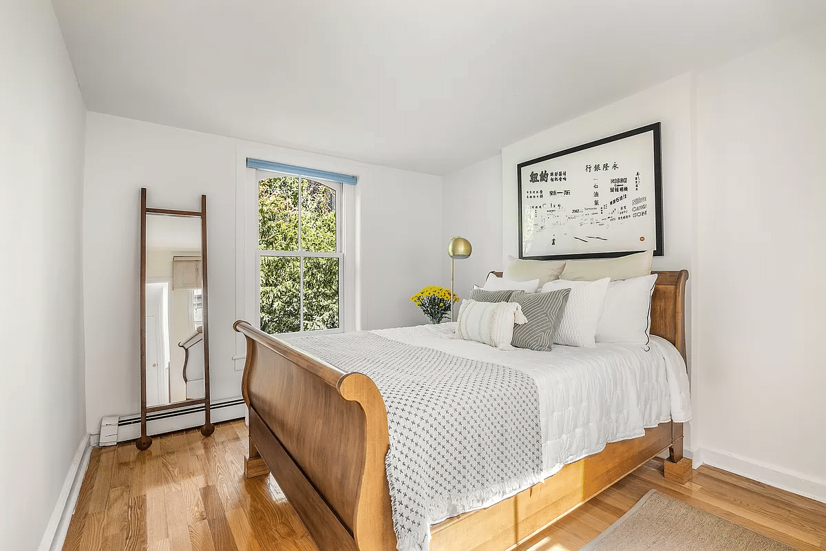 bedroom with base board heating, white walls