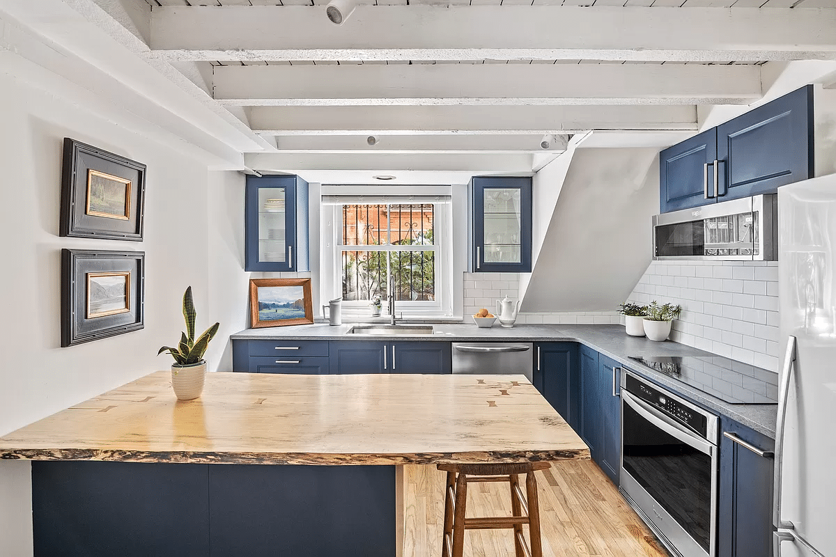 kitchen with blue cabinets, exposed beams