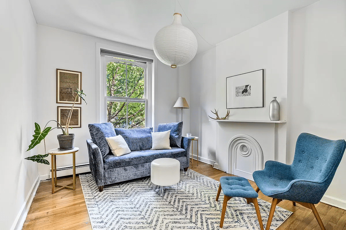 parlor with painted mantel, white walls, wood floor