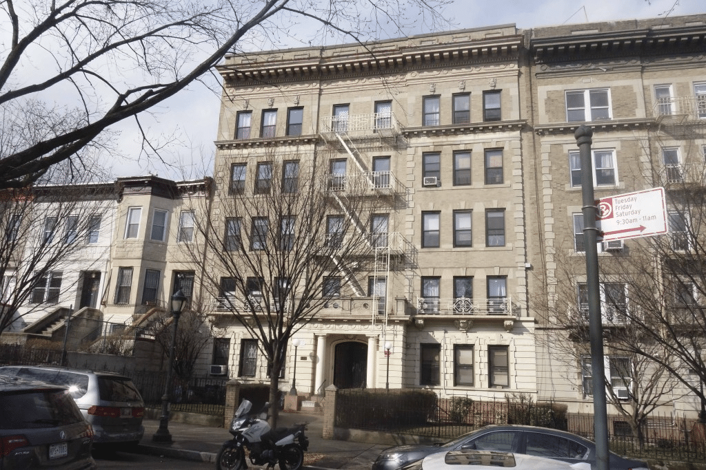 pale brick exterior of a five story building