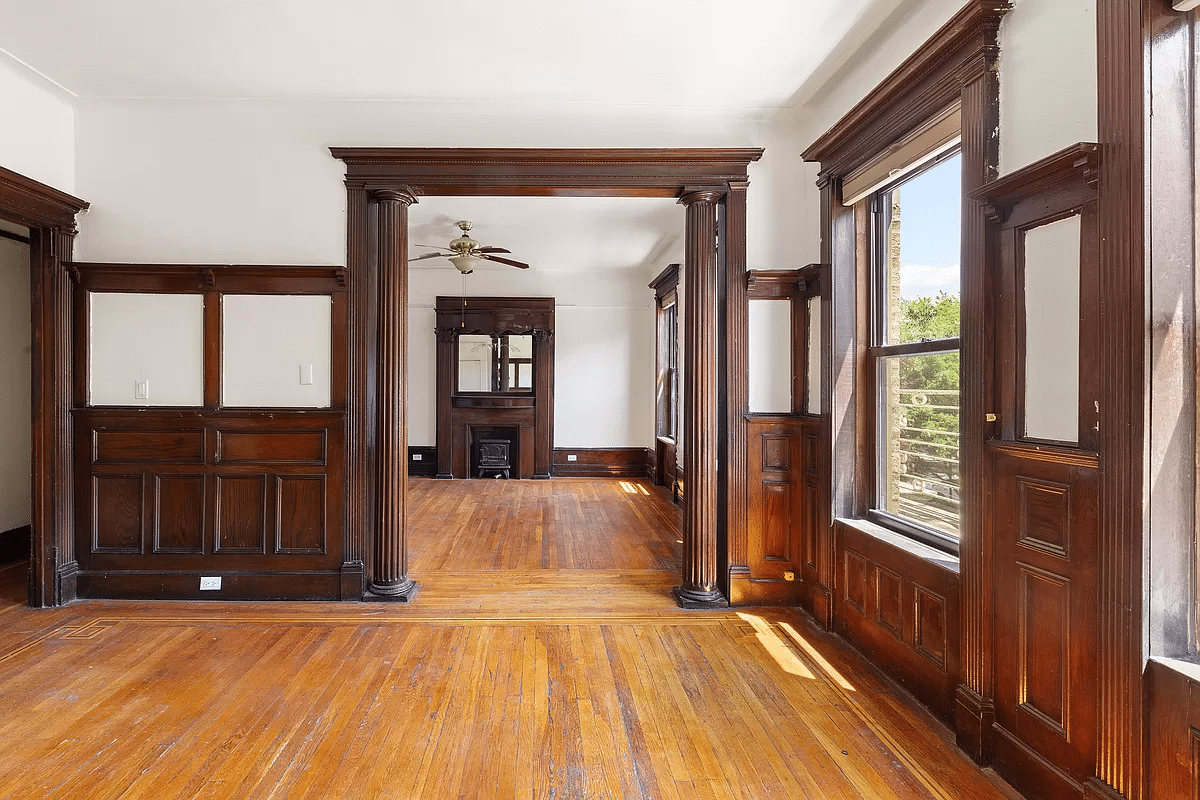 crown heights - columned doorway between dining room and living room with a view of a mantel