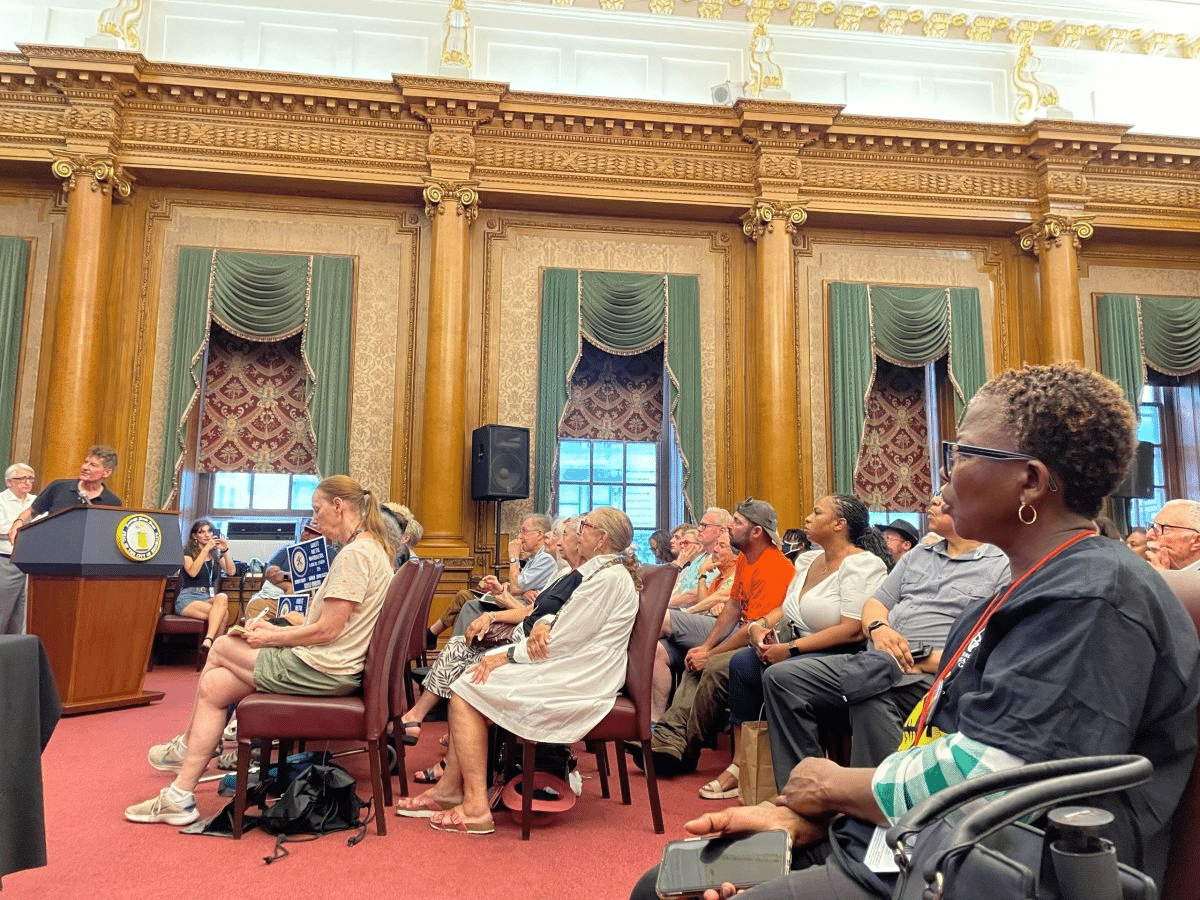 hearing - people sitting in a hearing room in brooklyn borough hall