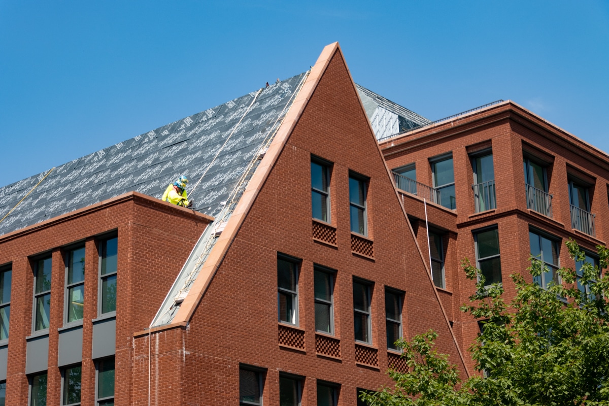 construction worker on the roof of the new Hebron School development