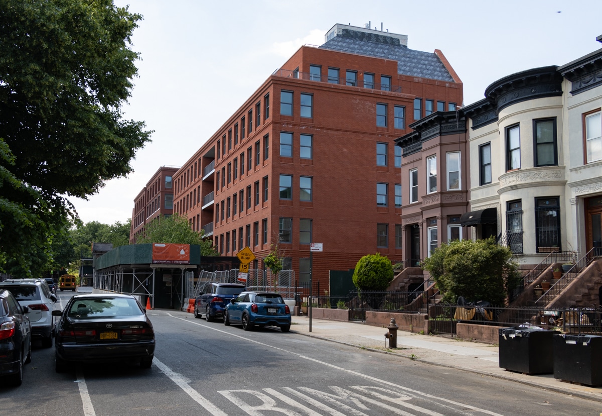 view of the new red brick buildings next to some older row houses